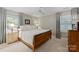 Bedroom featuring window shutters, neutral walls, ceiling fan, and stylish furniture at 6409 Ilex Ct, Charlotte, NC 28211