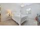 Bedroom featuring chandelier lighting, window shutters, neutral walls, and stylish furniture at 6409 Ilex Ct, Charlotte, NC 28211