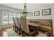Inviting dining room with a window view and unique chandelier at 6409 Ilex Ct, Charlotte, NC 28211
