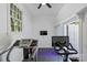 Exercise room with large windows, treadmill, stationary bike, and mounted television at 6409 Ilex Ct, Charlotte, NC 28211