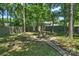 Circular fire pit area with stone pathways and lush foliage, offering a peaceful outdoor retreat at 6409 Ilex Ct, Charlotte, NC 28211