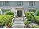 Inviting front entrance featuring a classic painted brick facade and landscaped steps at 6409 Ilex Ct, Charlotte, NC 28211