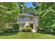 Charming painted brick home with a well-manicured lawn and lush landscaping at 6409 Ilex Ct, Charlotte, NC 28211