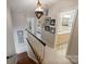 Hallway with pictures on the wall leading to bathroom and bedroom at 6409 Ilex Ct, Charlotte, NC 28211