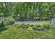 Landscaped garden bed with flowering plants bordering a well-maintained lawn at 6409 Ilex Ct, Charlotte, NC 28211