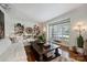Comfortable living room featuring hardwood floors, built-in shelving, and natural light at 6409 Ilex Ct, Charlotte, NC 28211
