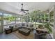 Inviting screened porch with comfortable seating and a ceiling fan, perfect for relaxing outdoors at 6409 Ilex Ct, Charlotte, NC 28211