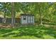 Charming backyard shed with double doors and window, adding storage and character at 6409 Ilex Ct, Charlotte, NC 28211