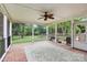 A screened-in back porch features an outdoor ceiling fan and a view of the yard at 6908 Lancer Dr, Charlotte, NC 28226