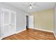 Bedroom with hardwood floors, ceiling fan and large double door closet at 6908 Lancer Dr, Charlotte, NC 28226