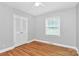 This bedroom features hardwood floors, a ceiling fan, a window, and a closet at 6908 Lancer Dr, Charlotte, NC 28226