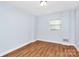 This bedroom features wood-look floors and a window at 6908 Lancer Dr, Charlotte, NC 28226