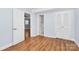 Bright bedroom features hardwood floors, neutral paint, and access to closet and ensuite at 6908 Lancer Dr, Charlotte, NC 28226