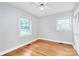 Light-filled bedroom features hardwood floors, ceiling fan and large windows at 6908 Lancer Dr, Charlotte, NC 28226