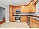 Well-lit kitchen features wooden cabinetry, stainless steel appliances, and a modern design at 6908 Lancer Dr, Charlotte, NC 28226