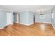 Open-concept living area featuring hardwood floors and neutral wall colors at 6908 Lancer Dr, Charlotte, NC 28226