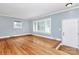 Bright, empty living room with hardwood floors, large windows, and fresh paint at 6908 Lancer Dr, Charlotte, NC 28226