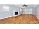 The spacious living room features wood-look floors and a brick fireplace at 6908 Lancer Dr, Charlotte, NC 28226