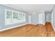 Sunlit living room with hardwood floors, large windows, and a welcoming atmosphere at 6908 Lancer Dr, Charlotte, NC 28226