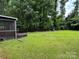 Expansive backyard featuring lush lawn and privacy with surrounding mature trees at 7316 Truelight Church Rd, Mint Hill, NC 28227