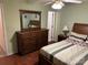 Comfortable bedroom featuring a wooden dresser with a mirror and hardwood flooring at 7316 Truelight Church Rd, Mint Hill, NC 28227