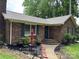 Brick home featuring a well-maintained lawn, classic shutters, and inviting front entryway at 7316 Truelight Church Rd, Mint Hill, NC 28227