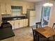 Bright kitchen with ample counter space, white cabinets, and access to an outdoor patio area at 7316 Truelight Church Rd, Mint Hill, NC 28227