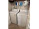 Convenient laundry area with washer, dryer, and shelving for supplies in this home at 7316 Truelight Church Rd, Mint Hill, NC 28227