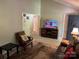 Inviting space featuring a large TV, comfortable chair, and direct access to the front door at 7316 Truelight Church Rd, Mint Hill, NC 28227
