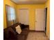 Comfortable living room featuring a cozy sofa, hardwood flooring and bright yellow walls at 7316 Truelight Church Rd, Mint Hill, NC 28227