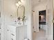 Well-lit bathroom with a vanity, arched mirror, and an adjacent shower area at 735 Davidson Run Ln, Davidson, NC 28036
