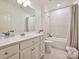 Well-lit bathroom with classic vanity, shower-tub combo, and neutral tile at 735 Davidson Run Ln, Davidson, NC 28036