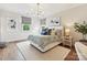 Cozy bedroom featuring a patterned bedspread, hardwood floors, and natural light from two windows at 735 Davidson Run Ln, Davidson, NC 28036