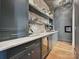 A butler's pantry/coffee bar area features cabinets, open shelves, and a beverage cooler at 735 Davidson Run Ln, Davidson, NC 28036