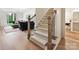 Inviting entryway features hardwood floors, staircase, and access to the living room at 735 Davidson Run Ln, Davidson, NC 28036