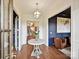 Bright foyer showcasing hardwood floors, elegant light fixture, and access to various rooms at 735 Davidson Run Ln, Davidson, NC 28036
