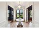 Elegant foyer featuring a hardwood floor, stylish lighting, and a view of the front yard at 735 Davidson Run Ln, Davidson, NC 28036