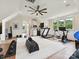 Spacious home gym featuring a kitchenette, modern fitness equipment, and plenty of natural light at 735 Davidson Run Ln, Davidson, NC 28036