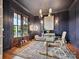 Sophisticated office with dark blue walls, natural light, and a stylish glass desk at 735 Davidson Run Ln, Davidson, NC 28036