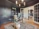 Elegant home office featuring hardwood floors, stylish lighting, and built-in shelving at 735 Davidson Run Ln, Davidson, NC 28036