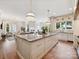 An extra large kitchen island opens up to living room space with fireplace and large bright windows at 735 Davidson Run Ln, Davidson, NC 28036