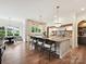 Bright, open kitchen features a large marble island with pendant lighting and bar stool seating at 735 Davidson Run Ln, Davidson, NC 28036