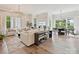Open-concept living room featuring hardwood floors, modern furniture, and a stylish chandelier at 735 Davidson Run Ln, Davidson, NC 28036