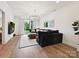 Sunlit living room with hardwood floors, stylish furnishings, and sliding doors to the outdoor space at 735 Davidson Run Ln, Davidson, NC 28036