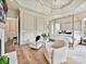 Spacious main bedroom featuring a canopy bed, sitting area, and decorative molding at 735 Davidson Run Ln, Davidson, NC 28036