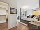 Serene main bedroom featuring a luxurious bed, hardwood floors, and ample natural light at 735 Davidson Run Ln, Davidson, NC 28036