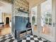 Charming mudroom with custom storage, decorative wallpaper, and access to the screened porch at 735 Davidson Run Ln, Davidson, NC 28036