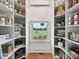 Walk-in pantry with organized shelving units and window showing outside at 735 Davidson Run Ln, Davidson, NC 28036
