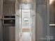 Built-in pantry opens to reveal a view of the front lawn, showing off a bonus design at 735 Davidson Run Ln, Davidson, NC 28036