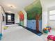 Spacious playroom with climbing walls, reading nook, playhouse, and ample room for activities at 735 Davidson Run Ln, Davidson, NC 28036